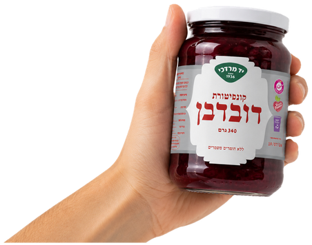 A hand holding the cherry jam jar
